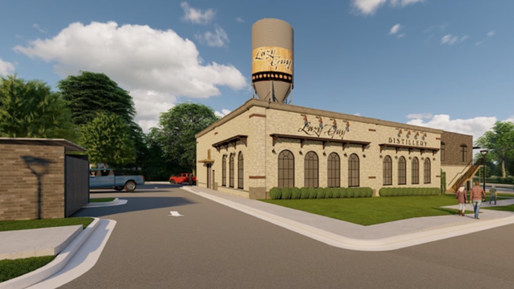 Architectural rendering of the new Lazy Guy Distillery building in Kennesaw: a cream masonry building with arched windows and a branded grain silo on the roof.